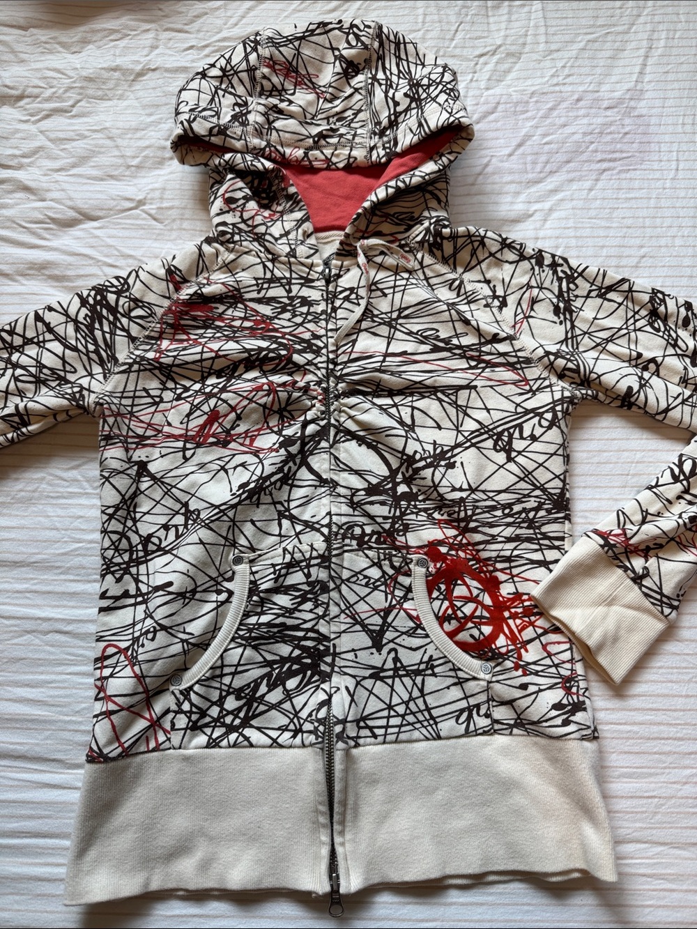 TNA Cream Hoodie with Black Scribble Print and Red Accents